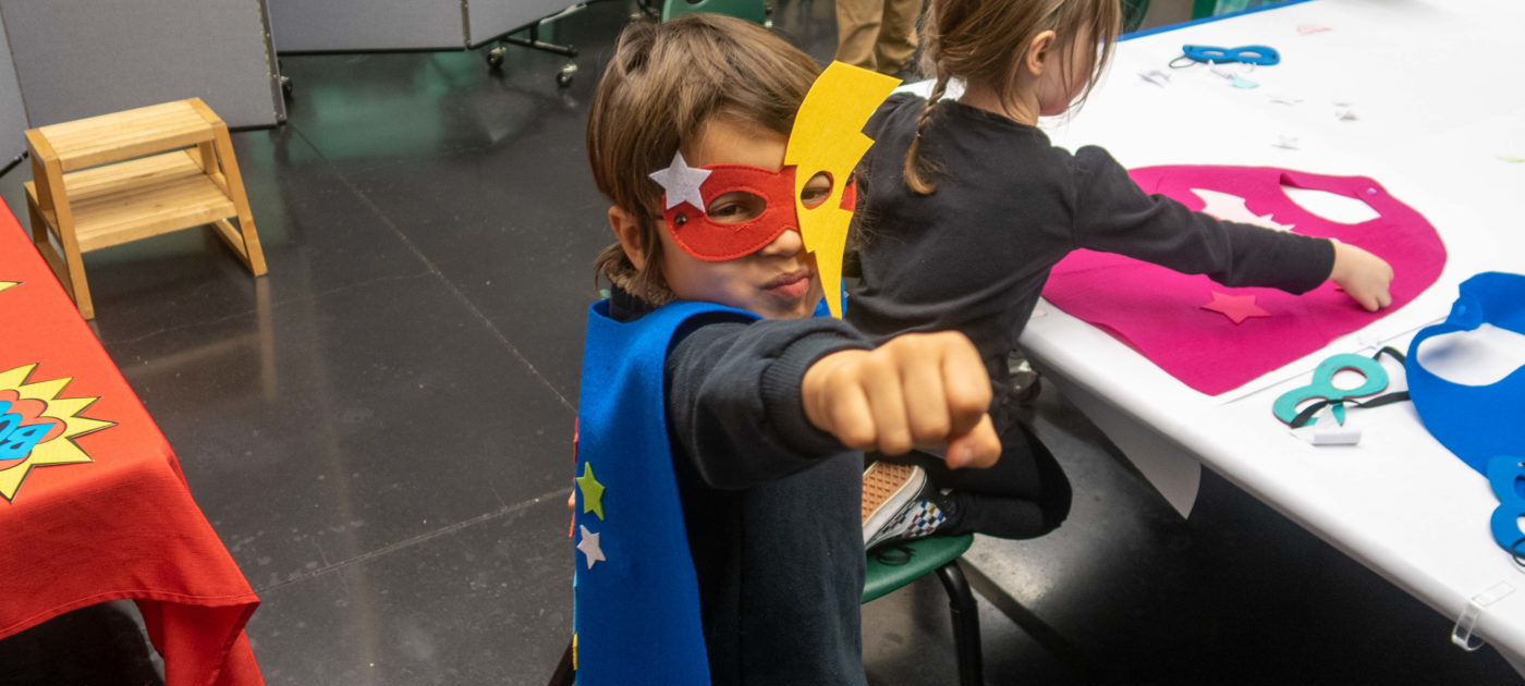 Child in a cape and mask