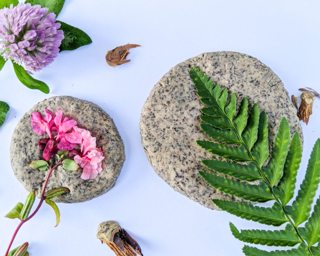 Leaves and flowers being pressed into clay