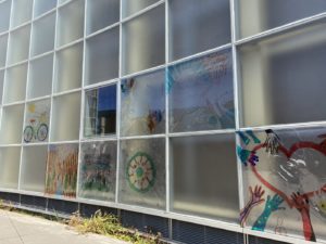 Wall of glass windows with drawings made by markers