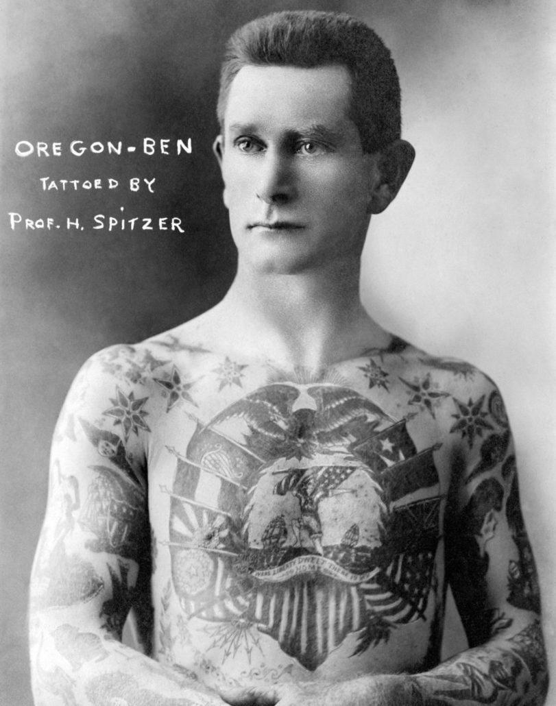 Shirtless man with tattoos on his arms and chest