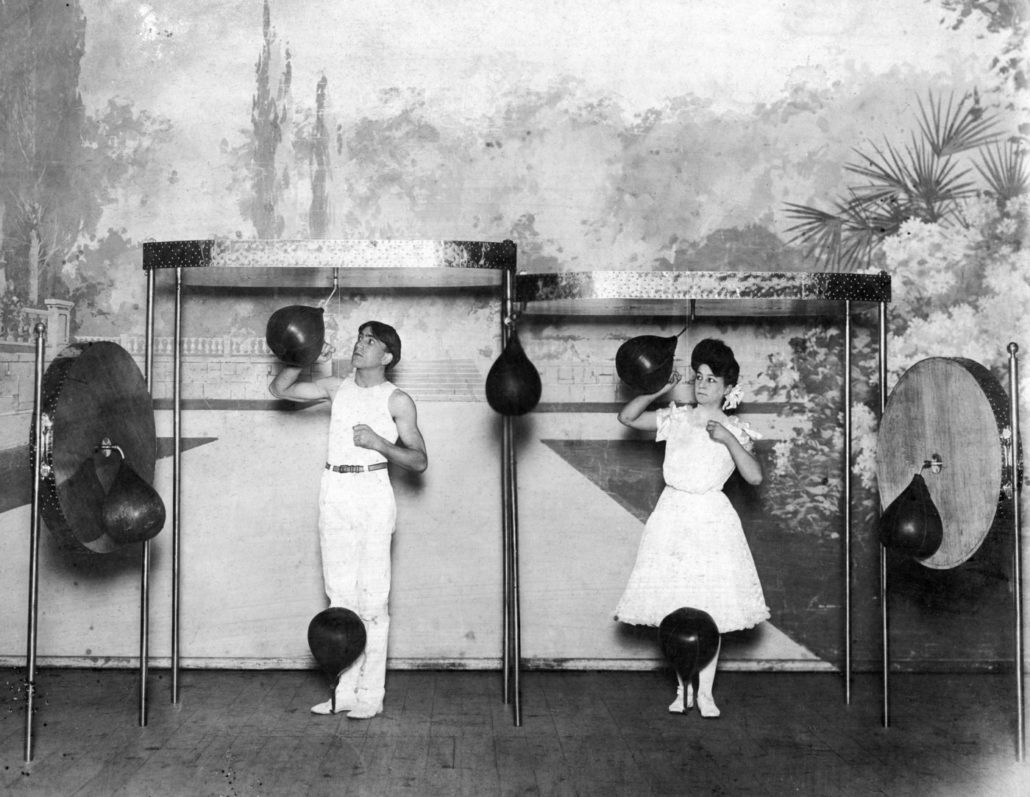 Man and woman hitting punching bags