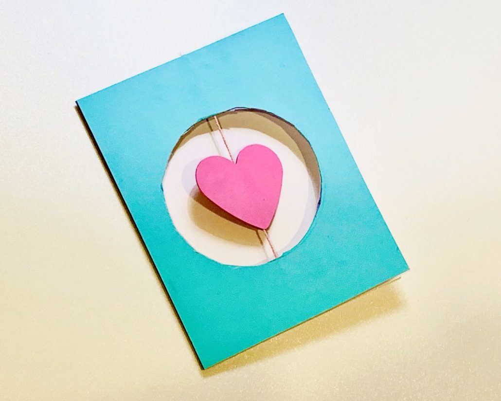 Card with paper heart in the middle