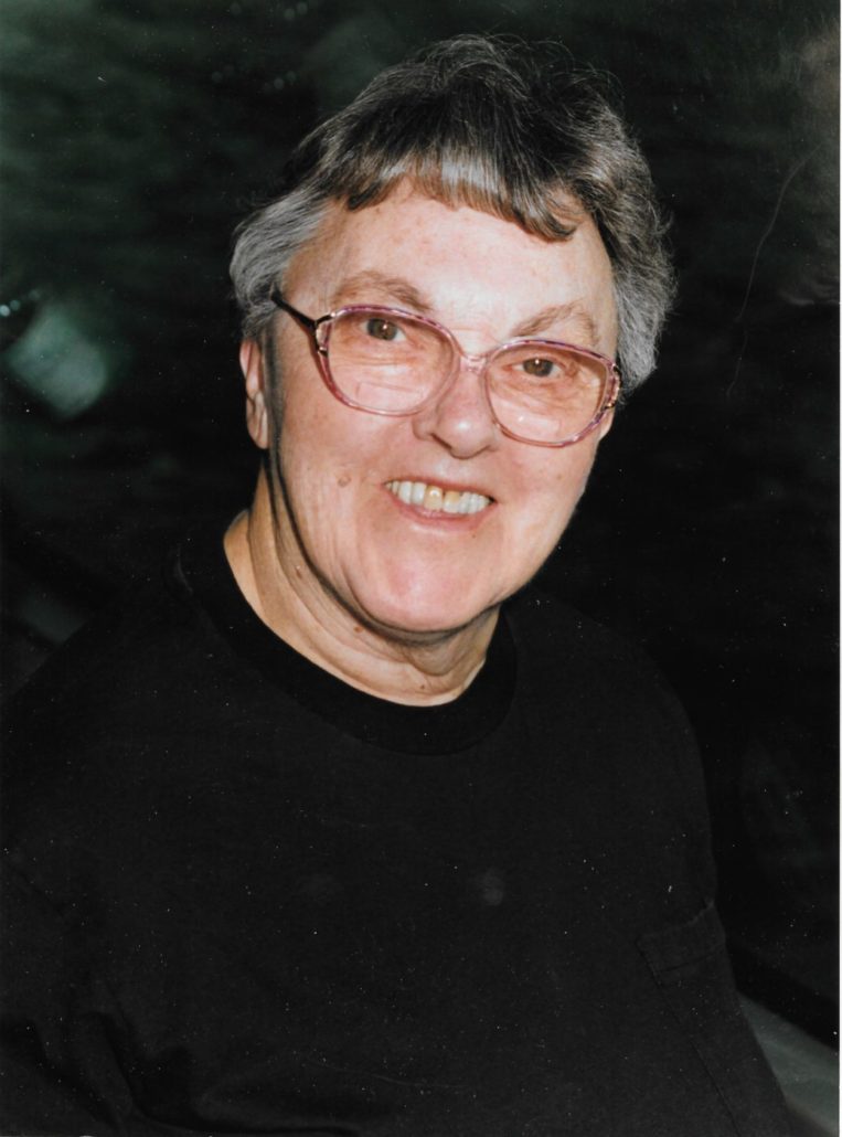 Woman with short hair and glasses smiling