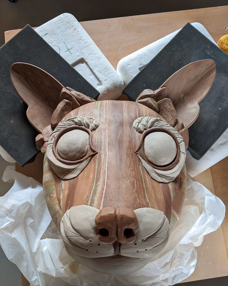 Brown clay animal sculpture with large ears