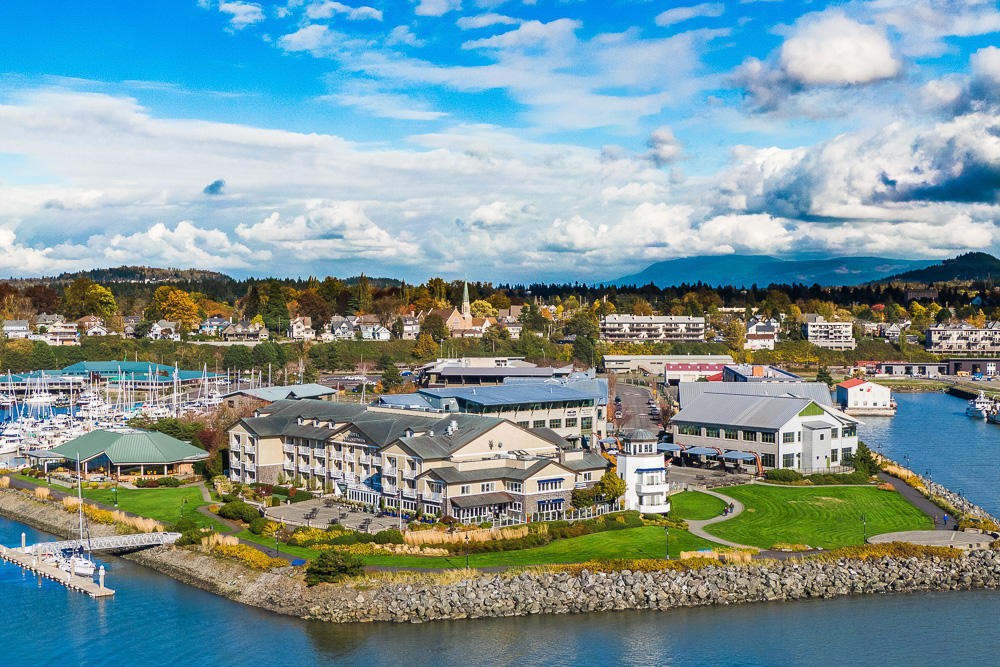 Aerial view of hotel on the waterfront with green lawn