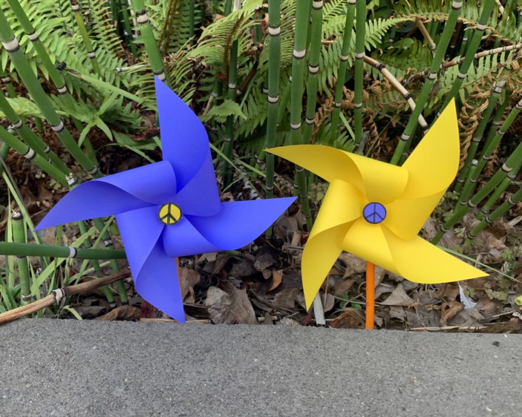 Two paper pinwheels stuck in the ground