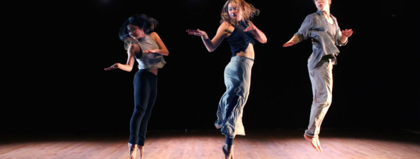 Three people jumping in the air