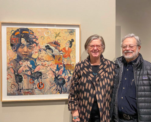 Driek and Michael Zirinsky stand in front of a painting