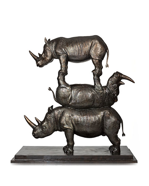 Bronze sculpture of three rhinoceros stacked on top of each other